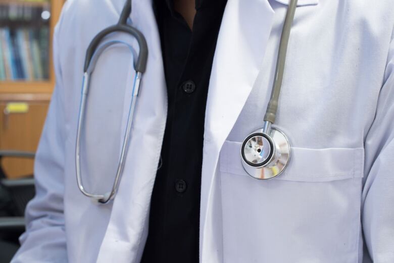 A close-up picture of a doctor with a lab coat and stethoscope. 