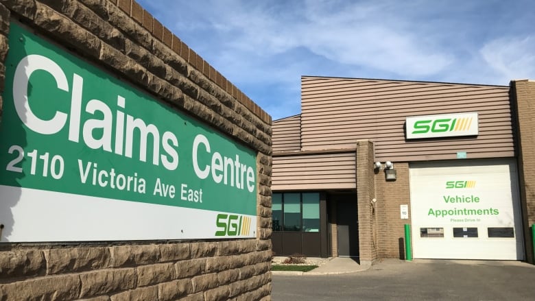 A sign for a claims centre in a parking lot.