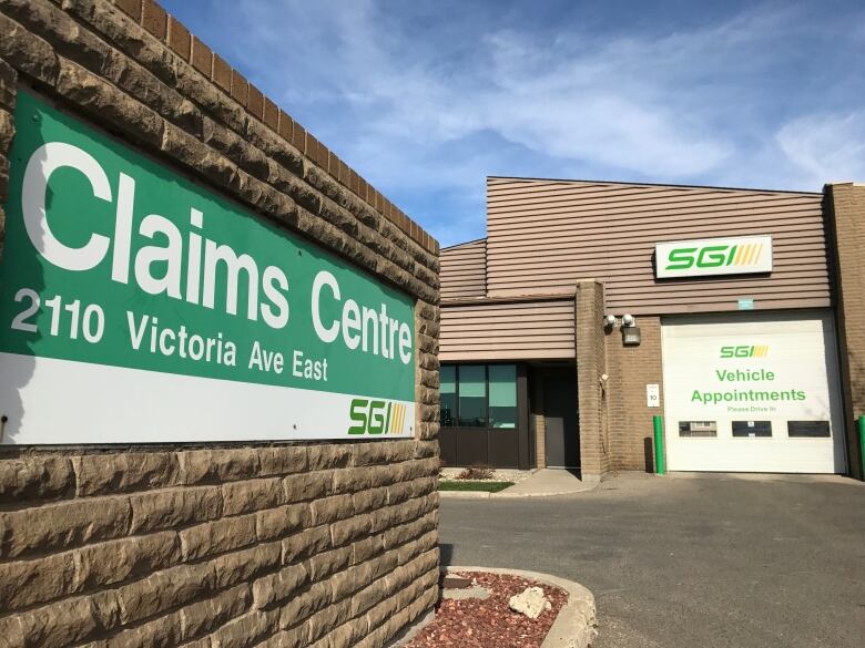 A sign for a claims centre in a parking lot.