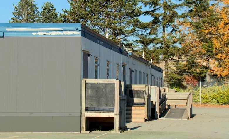 A row of portable classrooms on a school lot.