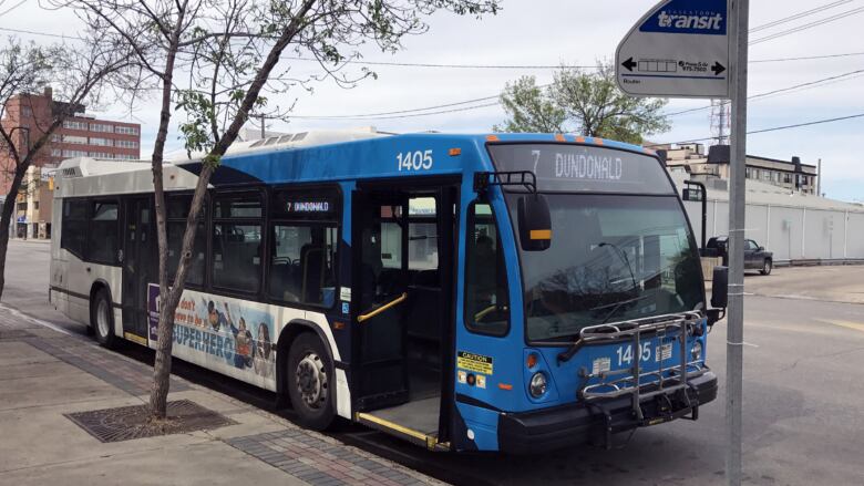 A city bus is parked on a street in saskatoon