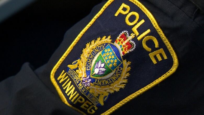 A photograph of a Winnipeg Police Service officer badge.