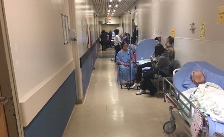 Patients waiting in a hospital hallway.