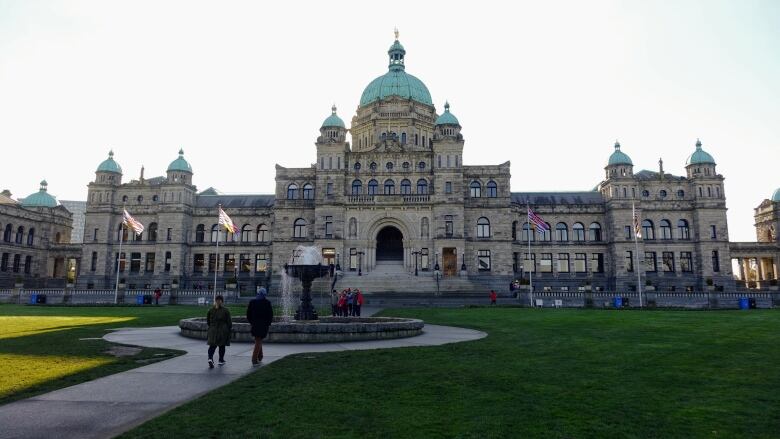 A cream colored legislative building with blue domes.