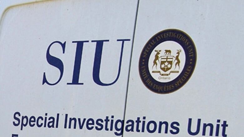 A close up of the back of a van that reads: Special Investigations Unit.