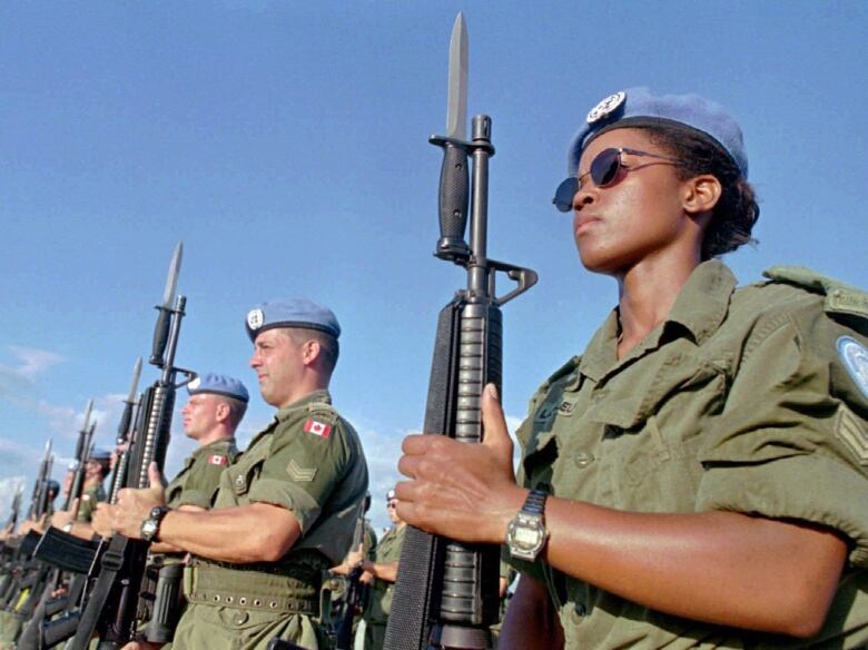 Canadian peacekeepers prepare for a parade at Maple Leaf Camp in Port-au-Prince on Nov. 28,1997. Canada is looking at ways to help other countries boost the number of female peacekeepers, despite having only a handful of Canadian women in blue helmets and berets.