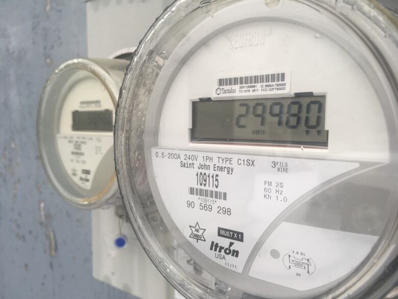 A close-up photo of a hydro meter on the side of a house. 