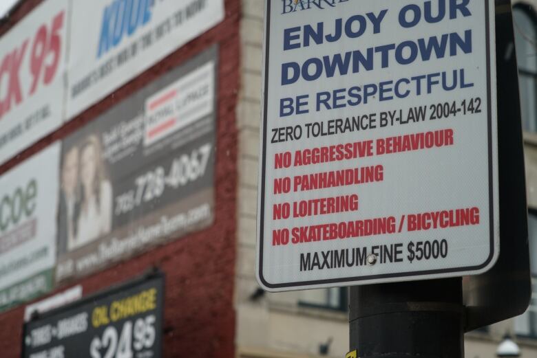 A close-up of a sign advising residents and visitors to be respectful in the downtown area.