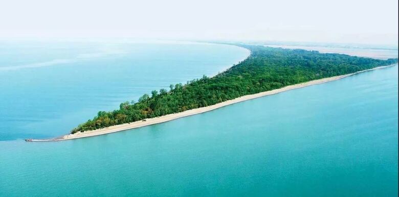 An aerial view of Point Pelee and the light blue water. 