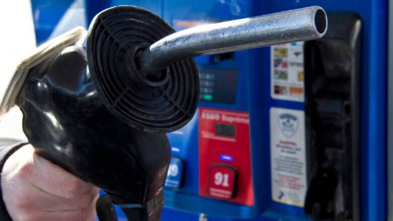 Close up of a hand holding a gas pump