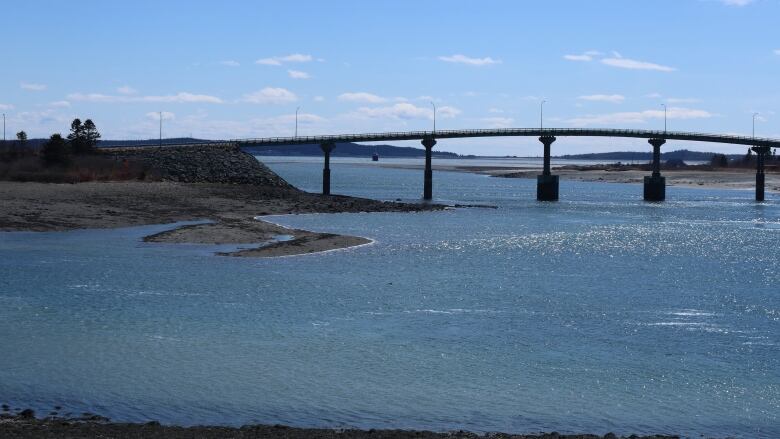 A bridge crossing deep blue water.