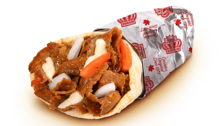 Meat, tomatoes and onion are wrapped in a pita and tin foil.