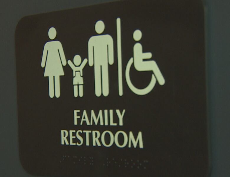 Close-up of a family washroom sign.