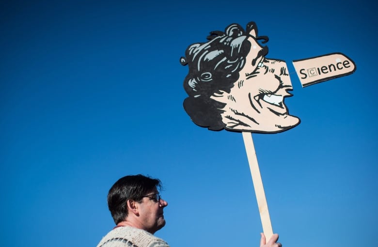 Scott McBride, of Nanaimo, B.C., holds a caricature of Prime Minister Justin Trudeau during a protest against the Kinder Morgan Trans Mountain pipeline expansion in Burnaby, B.C., on Saturday March 10, 2018.