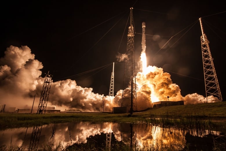 A rocket launches in the dark.