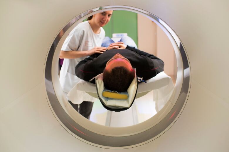 A patient entering a CT scanner is shown in this file photo.