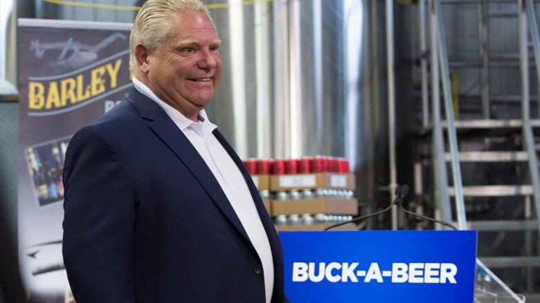 Ontario Premier Doug Ford is pictured at a brewery, beside a placard that reads 