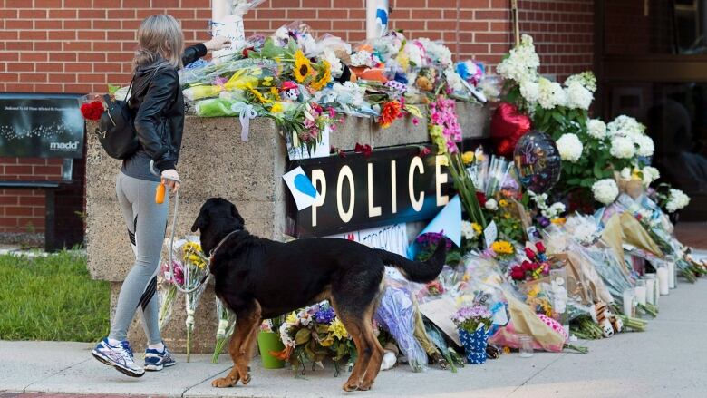 Flowers on the sign outside the Fredericton police station