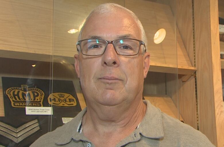 Retired correctional officer David Harvey is pictured in front of artifacts from Her Majesty's Penitentiary.