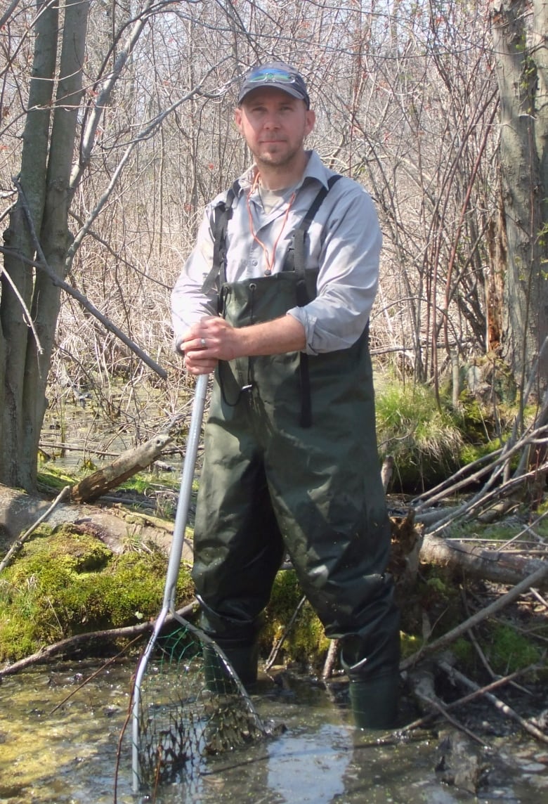 Scott Gillingwater, species at risk biologist with UTRCA, stands in a creek.