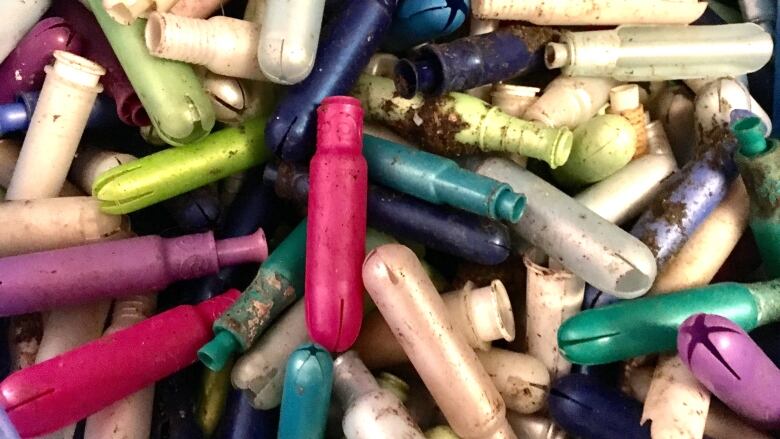 tampon applicators covered in sewage and dirt