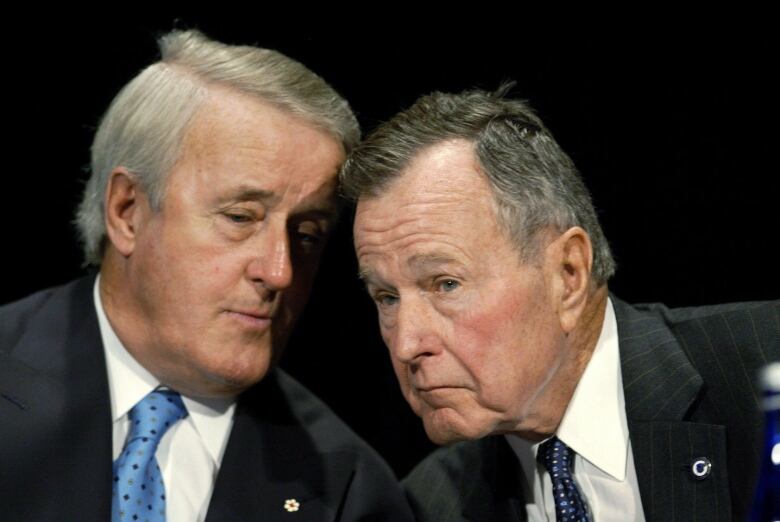 Former U.S. President George H.W. Bush, right, and former Canadian Prime Minister Brian Mulroney, left, gather for a conference on NAFTA at the Woodrow Wilson International Center for Scholars in Washington, Monday, Dec. 9, 2002. THE CANADIAN PRESS/AP-J. Scott Applewhite