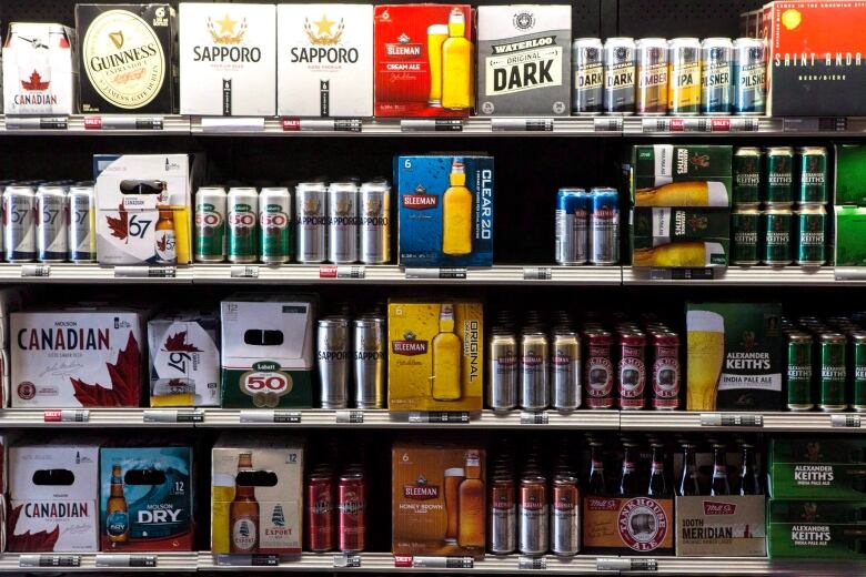  A range of beer products on shelves at a Beer Store outlet, including Guinness, Sapporo, Molson Canadian and Sleeman. 