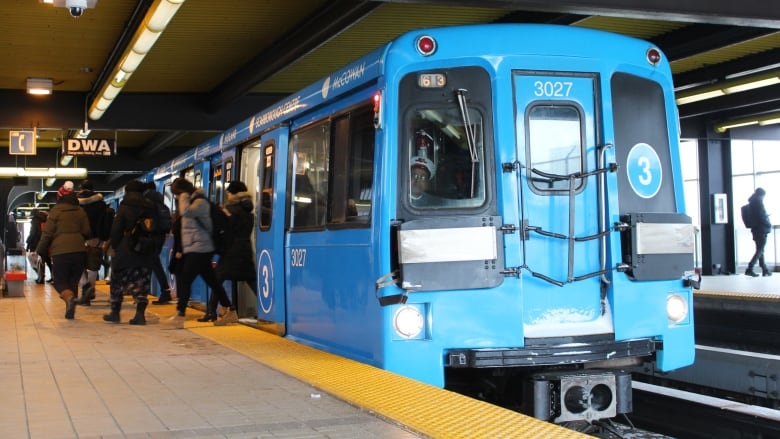 Blue light-rail train car.