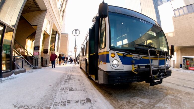 A Regina Transit bus stops to unload passengers on 11th Avenue in Regina. 