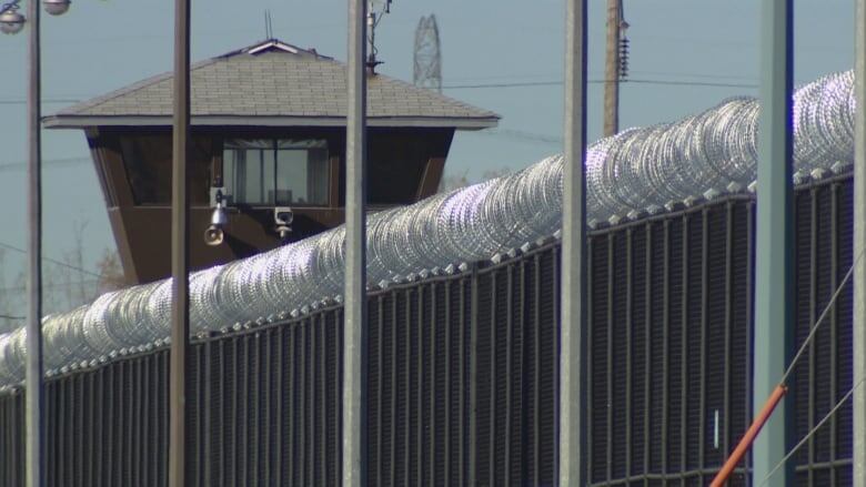 A prison with barbed wire.