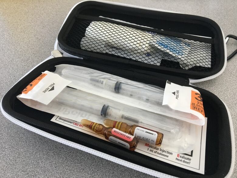 A kit containing two vials of naloxone, two syringes and alcohol swabs.