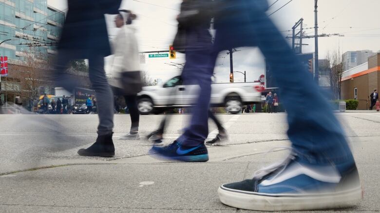 Pedestrians cross Cambie Street at Broadway. In 2011, Vancouver city officials said the intersection was one of a dozen being considered for a pedestrian scramble  but it never materialized.