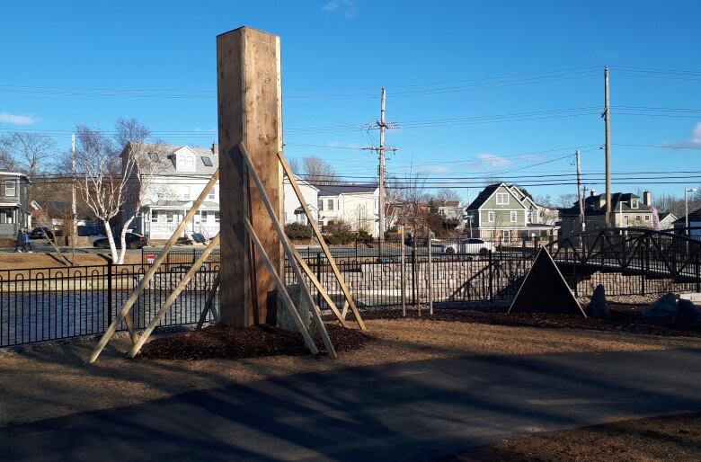 A tall box is shown in front of houses.