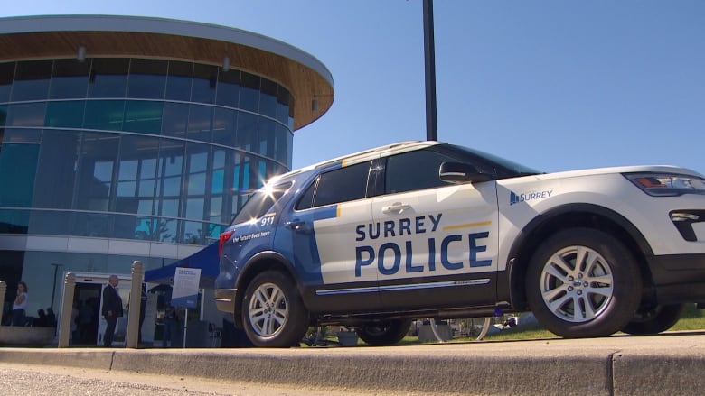 An SUV with the logo 'Surrey Police'.