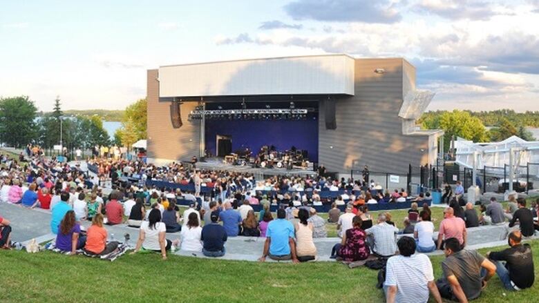 People sitting in front of an amphitheatre.