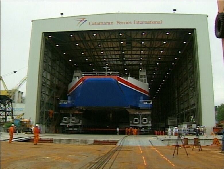 A giant ferry at a shipworker's yard.