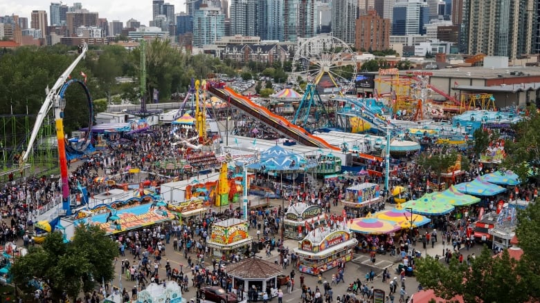 The midway grounds are seen with the Calgary skyline at the back. 