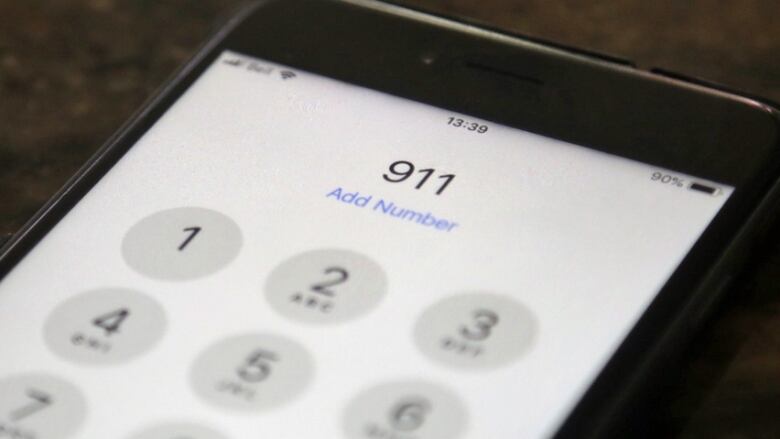 The numbers 911 on a cell phone screen.