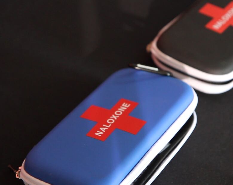 Two naloxone kits on a black background