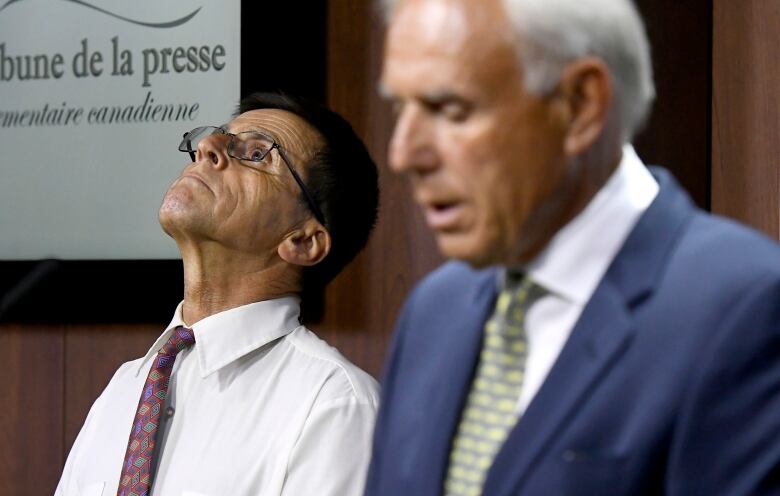 Hassan Diab, an Ottawa professor who was extradited to France after allegations of involvement in the 1980 bombing of a Paris synagogue, listens as his lawyer Donald Bayne responds to the release of an external review on his extradition by the Justice Department, during a press conference on Parliament Hill in Ottawa on Friday, July 26, 2019.