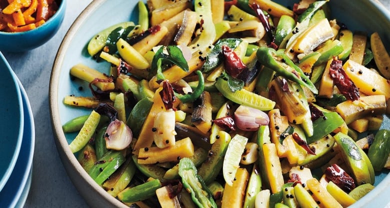 closeup on a plate of stir fry made with zucchini, plantains and green chiles