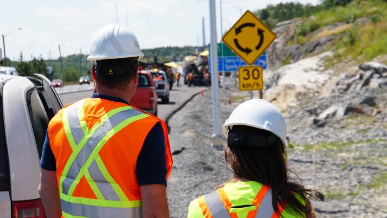 Two people looking at construction.