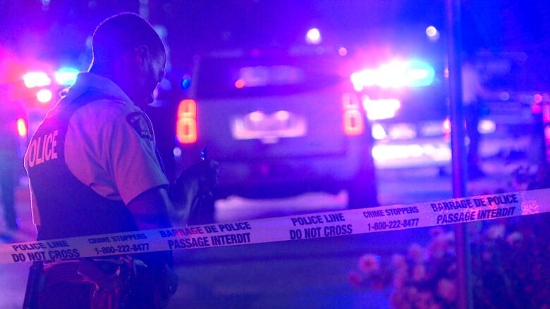 An RCMP officer takes notes just a few metres away from the scene in South Burnaby.