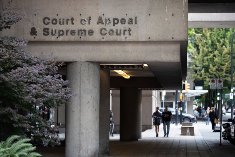 A building featuring a concrete overhang, with the label Court of Appeal & Supreme Court on the side, supported by two large pillars.