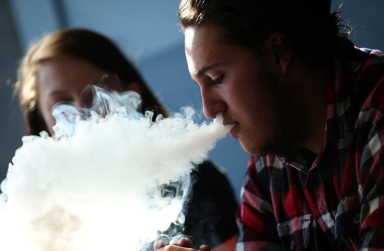 SAN RAFAEL, CA - JANUARY 28:  A customer smokes an E-Cigarette at Digita Ciggz on January 28, 2015 in San Rafael, California. The California Department of Public Health released a report today that calls E-Cigarettes a health threat and suggests that they should be regulated like regular cigarettes and tobacco products.