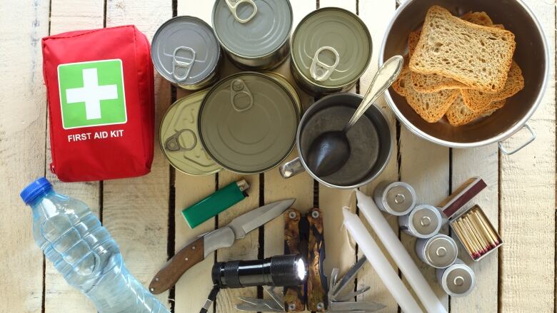 Photo of emergency kit supplies like water, canned food and batteries  