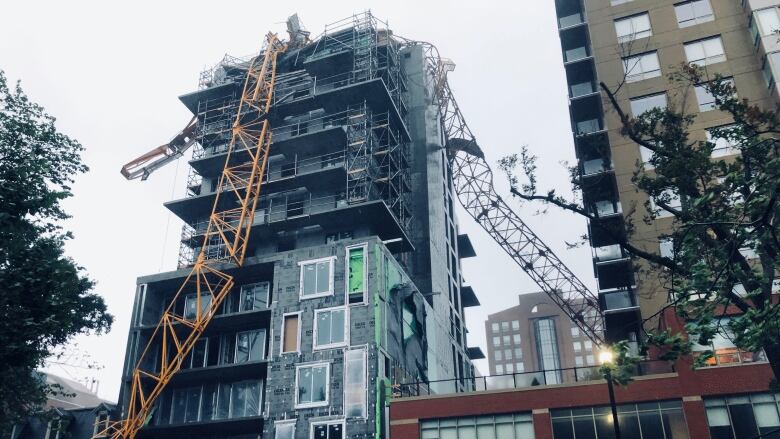 A crane on South Park Street in Halifax is seen toppled onto a building under construction.