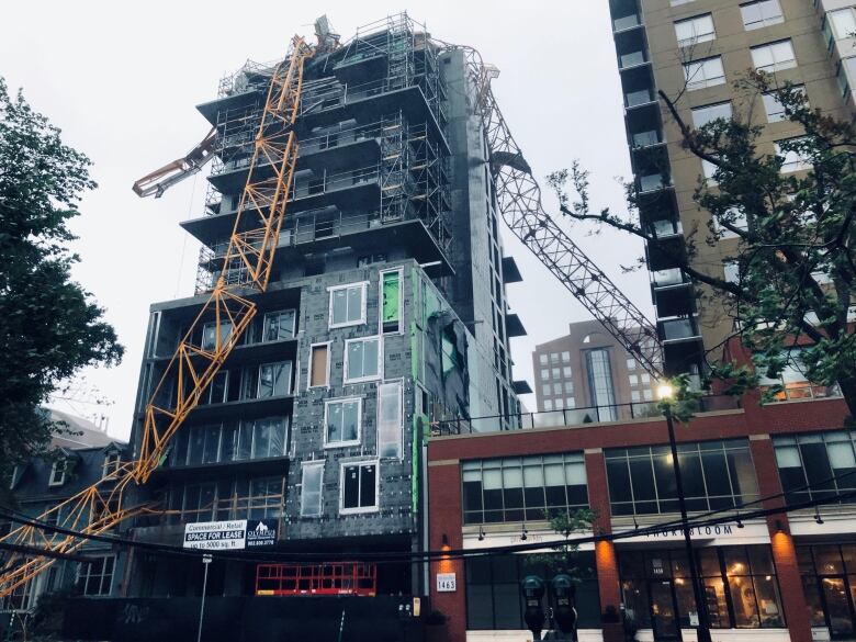 A crane on South Park Street in Halifax is seen toppled onto a building under construction.