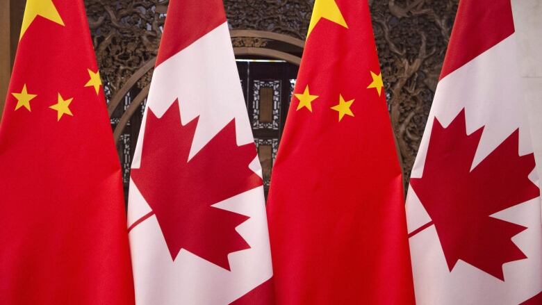 This Dec. 5, 2017, photo shows flags of Canada and China prior to a meeting of Canadian Prime Minister Justin Trudeau and Chinese President Xi Jinping at the Diaoyutai State Guesthouse in Beijing. A court in southern China handed down sentences Tuesday to at least six foreigners involved in an international methamphetamine operation, including a Canadian given the death penalty.