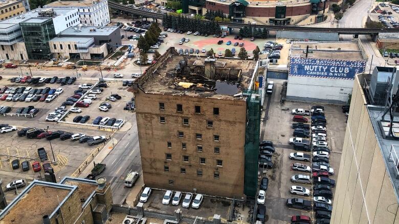 An overhead view of a warehouse building, with a roof damaged by fire.